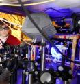 Ran Zhao and Yaroslav Dudin, graduate students in the Georgia Tech School of Physics, adjust optics in a system used to study quantum memory. Ran Zhao and Yaroslav Dudin, graduate students in the Georgia Tech School of Physics, adjust optics in a system used to study quantum memory.