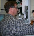 NIST chemist Tom Bruno demonstrates sampling of biodiesel fuel for injection into a gas chromatograph-mass spectrometer, an instrument that separates and identifies the components of a mixture.