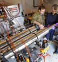 Issam Mudawar, from left, a Purdue professor of mechanical engineering, discusses a hydrogen-storage system for cars with graduate student Milan Visaria and Timothée Pourpoint, an assistant professor of aeronautics and astronautics and manager of the Hydrogen Systems Laboratory. Researchers have created the system's heat exchanger, which is critical because it allows the system to be filled quickly. The research is funded by General Motors Corp.