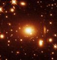 The massive radio galaxy PKS 0745-191, for which the cluster is named, appears at the center of this Hubble Space Telescope image. The picture forms the inset in the Suzaku image above. The massive radio galaxy PKS 0745-191, for which the cluster is named, appears at the center of this Hubble Space Telescope image. The picture forms the inset in the Suzaku image above.