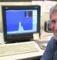 Michael T. Bowers is pictured with data on the Italian familial mutant of AB 42, a strain of Alzheimer's disease found in certain families of Italian descent.