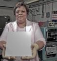 Wanda Petersof from NASA Goddard Space Flight Center in Greenbelt, Md.,  holds some material with the lotus coating on it.