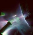This is an image of the infrared laser (not seen, entering from left-hand side) interacting with a flat target (center), and the associated plasma production from the interaction on the various diagnostic instruments in the chamber. This is a time integrated image over five seconds.