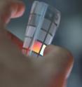Tougher than a bullet-proof vest yet synonymous with beauty and luxury, silks spun by worms and spiders are a masterpiece of nature whose properties have yet to be fully replicated in the laboratory. But Tufts University biomedical engineers report that success in unraveling the secrets of silk is taking silk from the world of textiles to technology. This silk card shows diffractive optics entirely constituted by pure silk obtained by pouring silk solution on nanopatterned molds and letting the solution dry and crystallize. The resulting film retains the pattern and is a free-standing optical component so flexible it can be rolled up. Tougher than a bullet-proof vest yet synonymous with beauty and luxury, silks spun by worms and spiders are a masterpiece of nature whose properties have yet to be fully replicated in the laboratory. But Tufts University biomedical engineers report that success in unraveling the secrets of silk is taking silk from the world of textiles to technology. This silk card shows diffractive optics entirely constituted by pure silk obtained by pouring silk solution on nanopatterned molds and letting the solution dry and crystallize. The resulting film retains the pattern and is a free-standing optical component so flexible it can be rolled up.