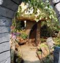 Only children really fit through the arch and in the tiny mushroom house (with its glowing roof), part of the Camden City Garden Club's Children's Garden exhibit.