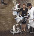 Johns Hopkins biomedical engineering students Erica Jantho, Hanlin Wan and Swarnali Sengupta test their team's ICU MOVER, a mobility aid designed to safely ambulate critical care patients.