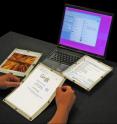 A prototype paper computer developed in Queen's Human Media Laboratory uses leaf turns to navigate documents.