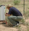 Dr. Brent Auvermann, Texas AgriLife Research engineer in Amarillo, downloads rainfall data from an electronic rain gauge used to calculate wet deposition as a part of the National Atmospheric Deposition Program.