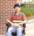Georgia Tech Electrical and Computer Engineering graduate student Xueliang Huo moves his tongue to direct the Tongue Drive system to move the powered wheelchair in a different direction.