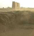 View towards the east, Tell Edfu in the foreground with the pylon of the Ptolemaic temple in the background.