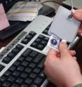 The NIST demonstration software provides examples of incorporating Personal Identity Verification cards to control access to government computers. As shown, an employee will have to swipe her PIV card that holds her unique identifying information before she can access her computer.