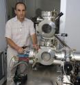 Physics Professor Michael Gershenson with laboratory equipment used to fabricate ultra-sensitive, nano-sized infrared light detector.