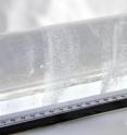 A section of ice core shows bands of bubbles frozen within the ice of McCall Glacier.