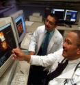 Dr. Vincent J.B. Robinson (right), nuclear cardiologist at the Medical College of Georgia and the Charlie Norwood Veterans Affairs Medical Center of Augusta, studies a nuclear scan of a heart with Dr. Dineshkumar Patel, internal medicine resident at MCG.