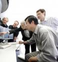 Professor Urban and his staff discuss the atomic structure of an oxide layer of nanoelectronics which is revealed in an electron microscope image. The Ernst Ruska-Centre in Jülich is a joint research platform of excellence operated by Forschungszentrum Juelich and RWTH Aachen University. As a national user center, it provides researchers from science and industry with access to the most powerful electron microscopes currently available. A profound understanding of atomic causes of material properties will provide the basis to tailor materials to specific problems.