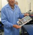 Engineer Dean White holds one of the detectors assembled at UCSB.