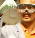 UCSD graduate student Ji-Ho Park holds a vial containing the nanometer-sized cargo ships, composed of a magnetic nanoparticle, a fluorescent quantum dot and an anti-cancer drug molecule that will be left on the site of the tumor.