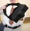 Samuel Krachman, D.O., holds Zzoma, a belt-like device worn during sleep to alleviate positional sleep apnea.