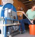 Sandia environmental scientist John Cochran demonstrates the pump used to extract groundwater samples from 150 meter deep monitoring wells at Sandia. (Photo by Michael Padilla).