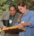 Secretary of Agriculture A. G. Kawamura admires bee stock with UC Davis bee breeder-geneticist Susan Cobey.