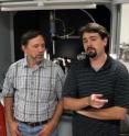 Graduate student Zachary Mensinger, left, talks with co-authors Lev N. Zakharov, center, and Darren Johnson in Zakharov's lab in the underground Lorry I. Lokey Laboratories at the University of Oregon.