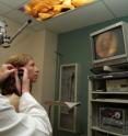 Glenn Green of the University of Michigan examines a patient's hearing.