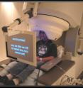 A research subject reads instructions on a screen while seated with his head surrounded by the MEG's magnetic detectors.