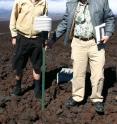 Steve Ryan and Kevin Hamilton inspect one of the atmospheric pressure sensors at the Mauna Loa Observatory.