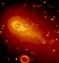 Swift's Ultraviolet/Optical Telescope (UVOT) captured Comet 73P/Schwassmann-Wachmann 3's fragment C as it passed the famous Ring Nebula (oval, bottom) on May 7, 2006. Swift watched as the crumbling comet left dusty blobs behind.