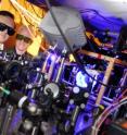 Associate professor Alex Kuzmich and research scientist Stewart Jenkins, both from the Georgia Tech School of Physics, adjust optics in a system used to study quantum memory.