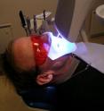 This is a person receiving a UV light-assisted tooth bleaching treatment.