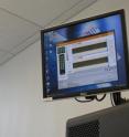 Colored patterns on the computer screen indicate variants in DNA bases from which researchers can decipher an individual's genome.