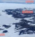 This is an Antarctic overview taken December 2008 showing Ace Lake in the center with the Long Fjord (marked by the red shelter) that connects to the ocean in the foreground, and the main Southern Ocean with icebergs in the background.