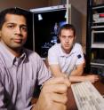 Raghunath Murali (left) and graduate student Kevin Brenner are shown with a test station used to study the properties of graphene.