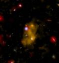 This composite image shows one of the brightest objects observed in a study of 29 blobs located in a single field. Glowing hydrogen gas in the blob is shown by a Lyman-alpha optical image (colored yellow) from the Subaru telescope. A galaxy located in the blob is visible in a broadband optical image (white) from the Hubble Space Telescope and an infrared image from the Spitzer Space Telescope (red). Finally, the Chandra X-ray Observatory image (blue) shows evidence for a growing supermassive black hole in the center of the galaxy. Radiation and outflows from this active black hole are lighting up and heating the gas in the blob.