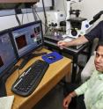 Philip Low, the Ralph C. Corley Distinguished Professor of Biochemistry at Purdue, and graduate student Sumith Kularatne, in foreground, examine the uptake of an imaging agent in prostate cancer cells. Low led a research team that designed a molecule to find and penetrate prostate cancer cells and has created imaging agents and therapeutic drugs that can link to the molecule and be carried with it as cargo.