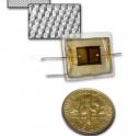 The aluminum substrate shown at top rear is patterned with pores seeded with anodized gold, spaced at intervals of about half a micron (millionth of a meter). At middle rear, the single-crystal cadmium sulfide nanopillars are about 200 nanometers in diameter (billionths of a meter). The test device in the foreground is shown next to a dime for scale.