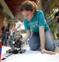 Purdue undergraduate engineering student Jessie Powell redirects her team's robot as it tries to follow a line on its way to lifting a weighted aluminum can. New research findings suggest that, contrary to popular belief, engineering students don't have a higher dropout rate than students in other majors and women do just as well as their male counterparts, information that could lead to a strategy for boosting the number of US engineering graduates.