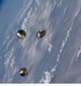 The ANDE-2 spacecraft, Castor and Pollux, shortly after deployment from Space Shuttle Endeavour on July 30, 2009. The avionics deck of the ICU is also visible on the right side of the photograph.