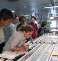 An international group of scientists examines the cores in the shipboard laboratory. An international group of scientists examines the cores in the shipboard laboratory.
