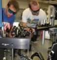 Alex High and Aaron Hammack adjust the optics in their UCSD lab.