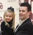 Johnathan Russell holds his 3-year-old daughter Maddison while talking to reporters at the University of Oklahoma Health Sciences Center about his childhood cancer and his fear that radiation treatment would affect his children.