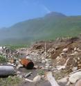 In the summer of 2006, this area strewn with rocks and logs near the shore of Ainu Bay on Matua Island in the Kurils was covered by about 6 feet of sand and soil, about even with the top of the 6-foot-6 white rod in the center of the photo. When researchers had excavated there previously they did not encounter any of the boulders they later found exposed by the tsunami.