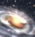 This is an artist's concept of a quasar (bright area with rays) embedded in the center of a galaxy. This is an artist's concept of a quasar (bright area with rays) embedded in the center of a galaxy.