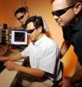 Georgia Tech researchers Yaguang Wei, Zhong Lin Wang and Benjamin Weintraub (left-right) examine a prototype of their three-dimensional solar cell based on optical fiber.