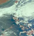 NASA's Aqua satellite captured this visible image of 97W, or "Tino" early this morning, Nov. 2 at 12:23 a.m. EDT (1:23 p.m. local time) and showed 97W's clouds are already spreading over the northern Philippines.