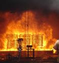 Researchers conducts well deck fire suppression tests.