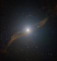 This image of the central parts of Centaurus A reveals the parallelogram-shaped remains of a smaller galaxy that was gulped down about 200 to 700 million years ago. The image is based on data collected with the SOFI instrument on ESO's New Technology Telescope at La Silla. The original image, obtained by observing in the near-infrared through three different filters (J, H and K) was specially processed to look through the dust, providing a clear view of the center. The field of view is about 4 x 4 arcminutes. This image of the central parts of Centaurus A reveals the parallelogram-shaped remains of a smaller galaxy that was gulped down about 200 to 700 million years ago. The image is based on data collected with the SOFI instrument on ESO's New Technology Telescope at La Silla. The original image, obtained by observing in the near-infrared through three different filters (J, H and K) was specially processed to look through the dust, providing a clear view of the center. The field of view is about 4 x 4 arcminutes.