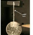 A yarn spun of boron-nitride nanotubes suspends a quarter. The nanotubes in this yarn were produced with a new technique discovered by researchers at NASA's Langley Research Center, the Department of Energy's Thomas Jefferson National Accelerator Facility and the National Institute of Aerospace. The nanotubes are highly crystalline and have a small diameter. They also structurally contain few walls and are very long. A yarn spun of boron-nitride nanotubes suspends a quarter. The nanotubes in this yarn were produced with a new technique discovered by researchers at NASA's Langley Research Center, the Department of Energy's Thomas Jefferson National Accelerator Facility and the National Institute of Aerospace. The nanotubes are highly crystalline and have a small diameter. They also structurally contain few walls and are very long.
