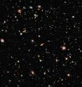 In 2004, Hubble created the deepest visible-light image of the Universe and now, with its brand-new camera, Hubble is seeing even farther in the same region. Hubble's newly installed Wide Field Camera 3 collects light from near-infrared wavelengths and therefore looks even deeper, because the light from hot young stars in very distant galaxies is stretched out of the ultraviolet and visible regions of the spectrum into near-infrared wavelengths by the expansion of the Universe. The new deep view also provides insights into how galaxies grew in their formative years early in the universe's history. This image is a composite of separate exposures made by the WFC3 instrument on the Hubble Space Telescope. Three filters were used to sample broad wavelength ranges in the near-infrared. The color results from assigning different colors to each monochromatic image. In this case, the assigned colors are: F105W (Y) blue, F125W (J) green and F160 (H) red. The image is roughly 2.4 arcminutes wide.